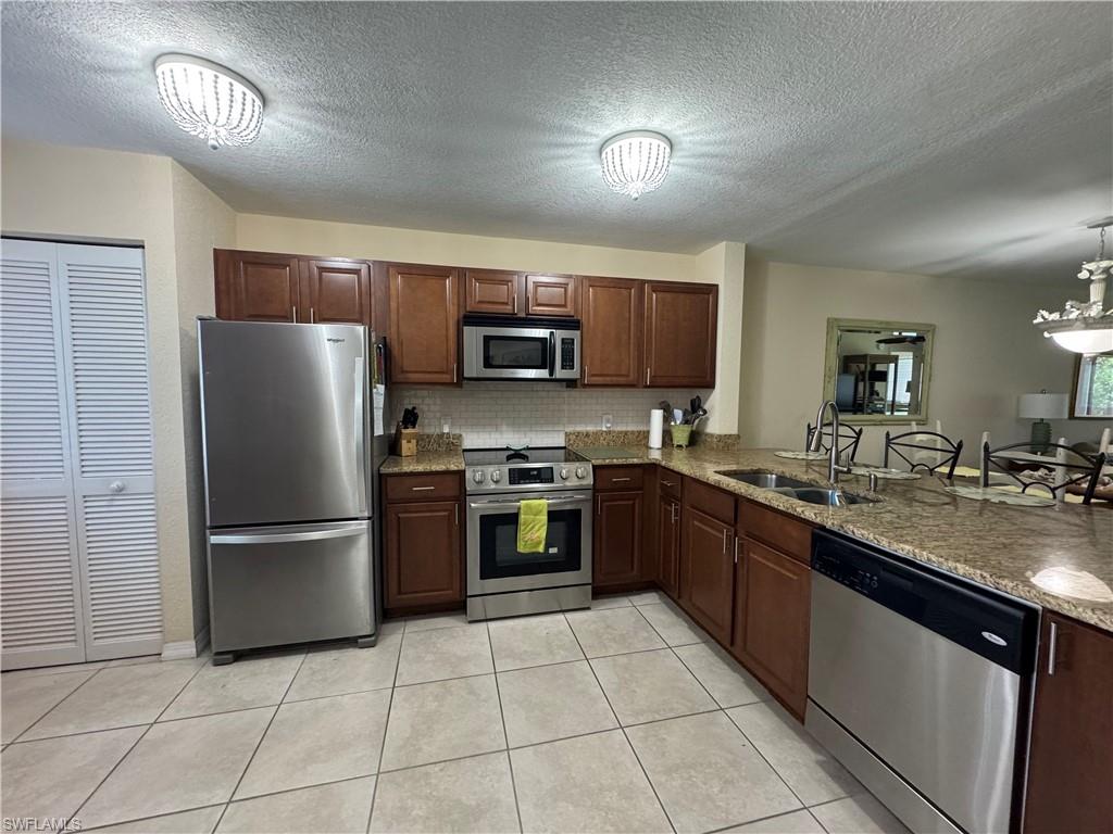 Stainless appliances and tile flooring