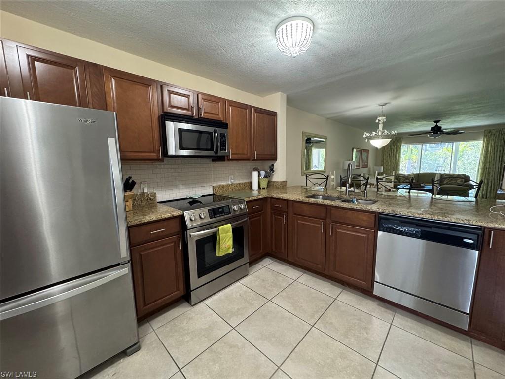 Tiled kitchen with stainless appliances