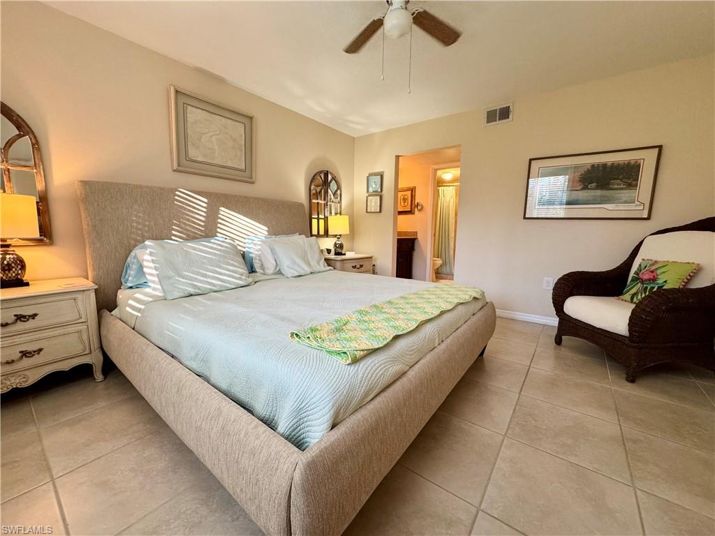 Primary bedroom with king size bed and ensuite bathroom