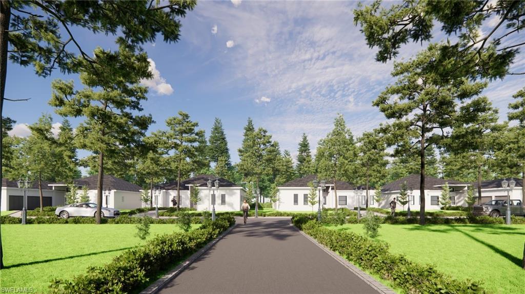 Paved community road bordered by manicured hedges and mature trees