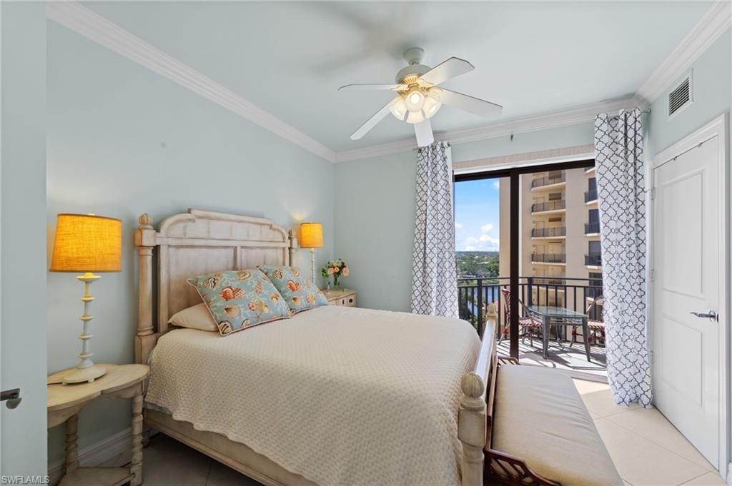 The room features a private balcony with water views and a ceiling fan