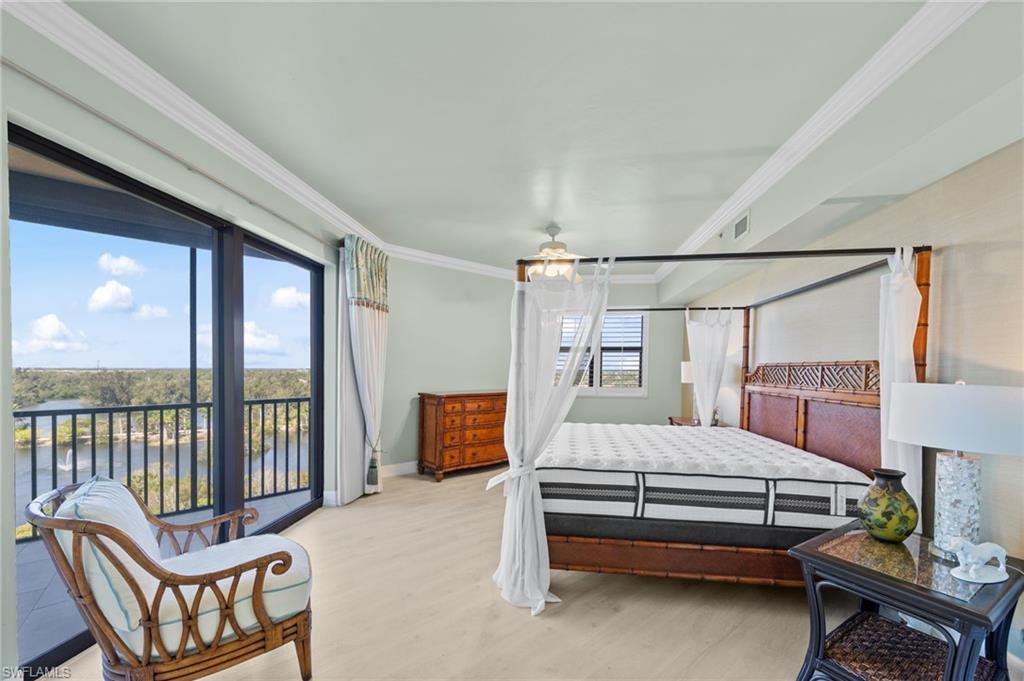 The bedroom features light-colored flooring, a glass sliding door providing access to a balcony, and a window with horizontal blinds
