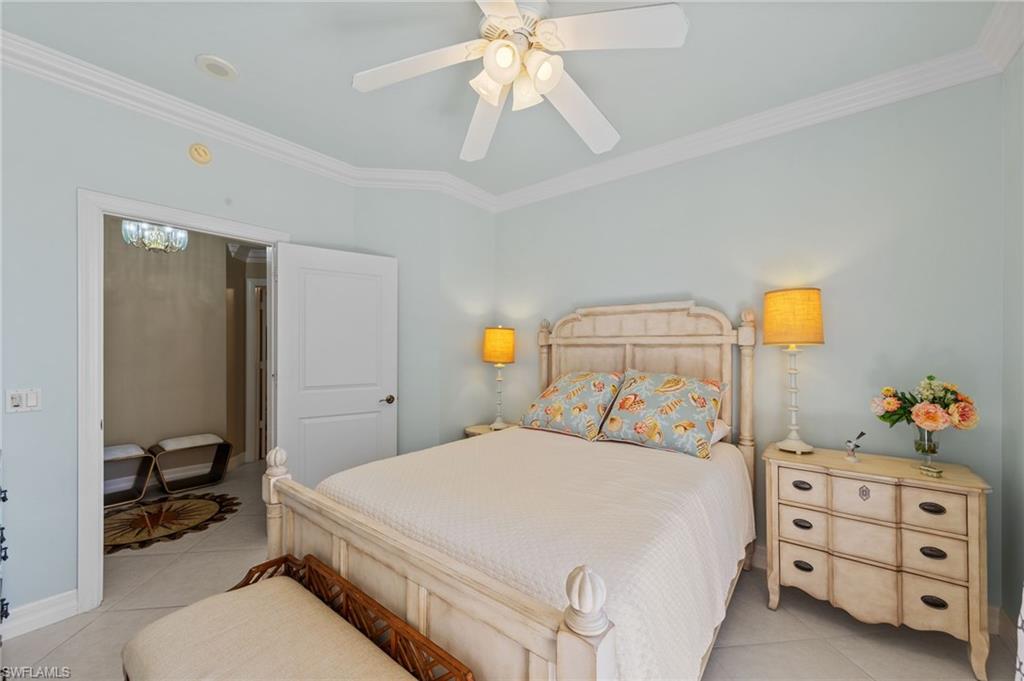 This room features a ceiling fan, crown molding, and light blue walls
