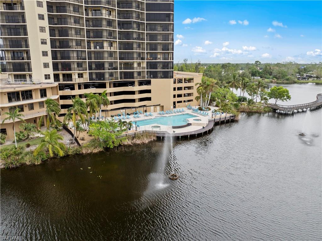 The property features a waterfront swimming pool and a sun deck with lounge chairs