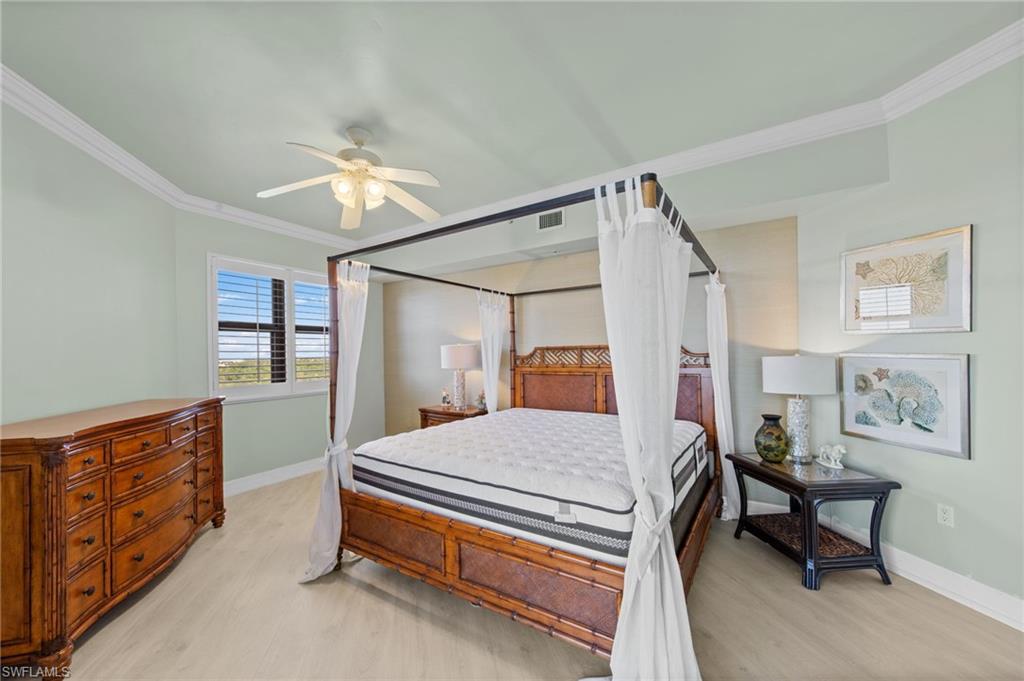 Bedroom featuring light-colored flooring, a window with horizontal blinds, and a ceiling fan