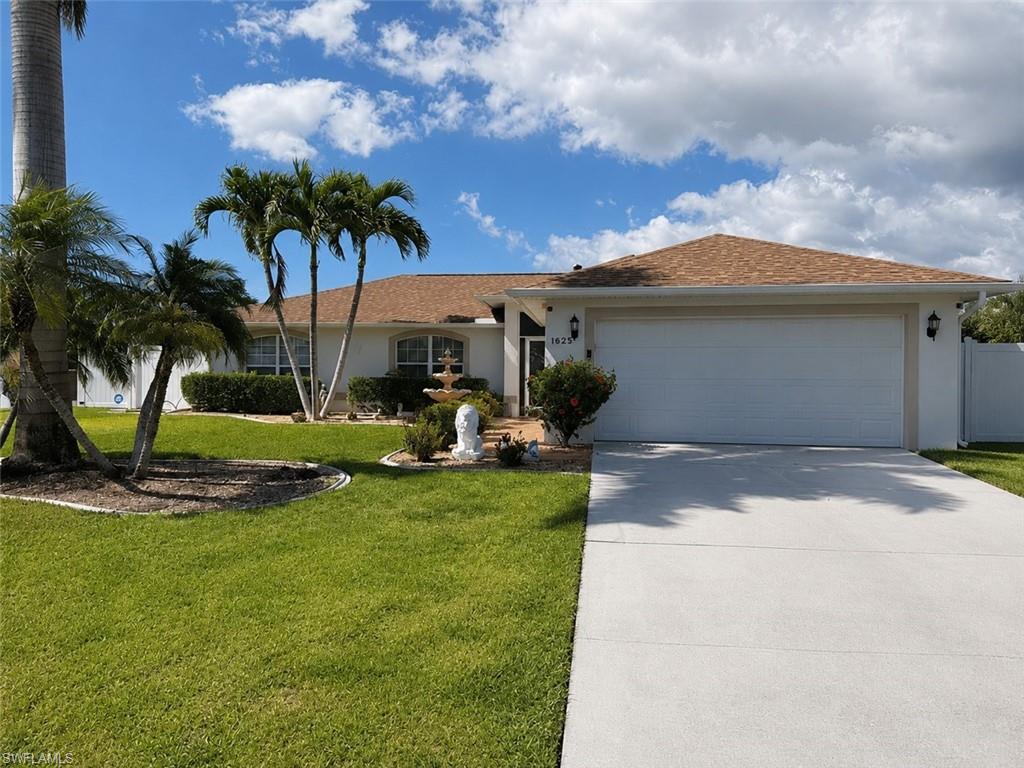 Single-story residence featuring a two-car garage, concrete driveway, and a shingle roof