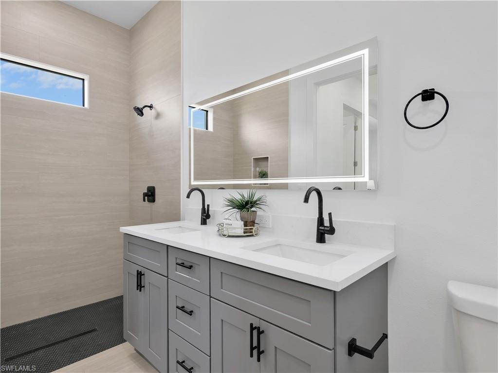 Dual vanity with white countertop and gray cabinetry  photos used from another listing to show what it would look like with furniture