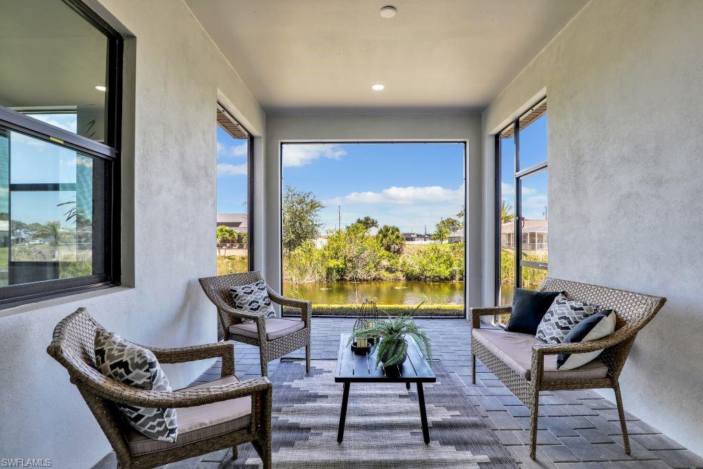 Covered patio featuring a large rectangular opening to the outdoors, a water feature, and a paved flooring surfacephotos used from another listing to show what it would look like with furniture
