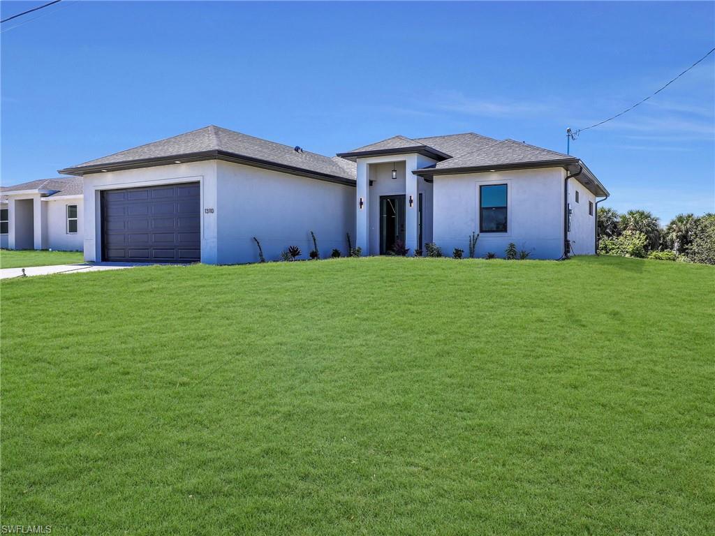 Contemporary stucco exterior with dark trim accents  the color of the grass has been virtually enhanced