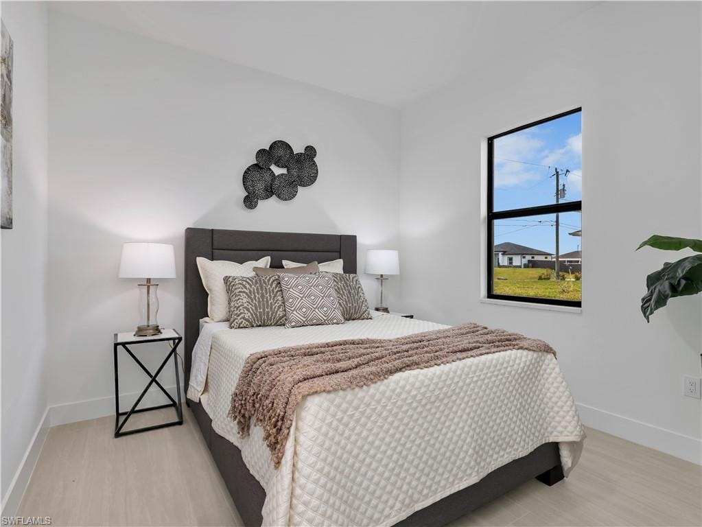 Bright interior with light wood-finish flooring and a large window  photos used from another listing to show what it would look like with furniture
