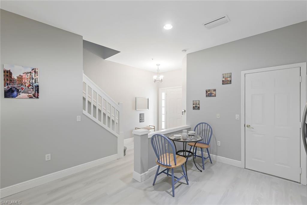 Foyer with light hardwood / wood-style floors and an inviting chandelier