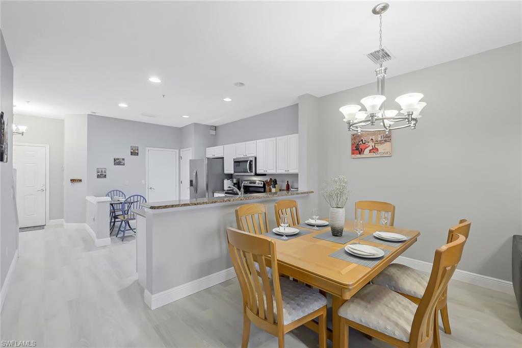 Dining room featuring an inviting chandelier and light wood-type flooring