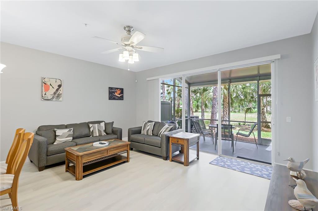 Living room featuring wood-type flooring and ceiling fan