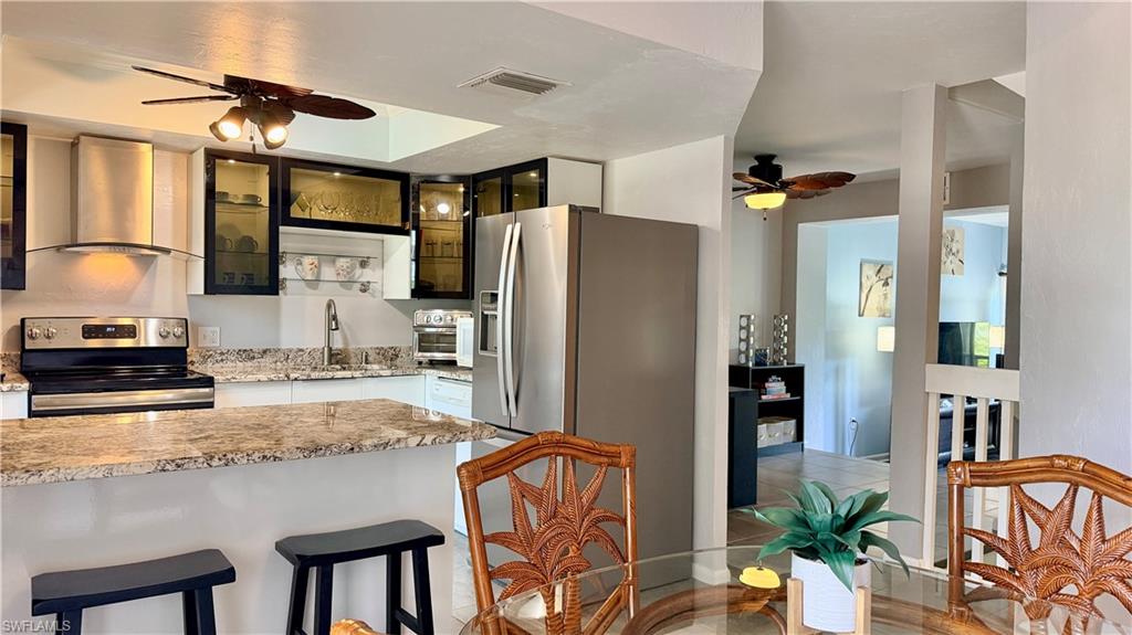 KITCHEN, BREAKFAST BAR, DINING AREA