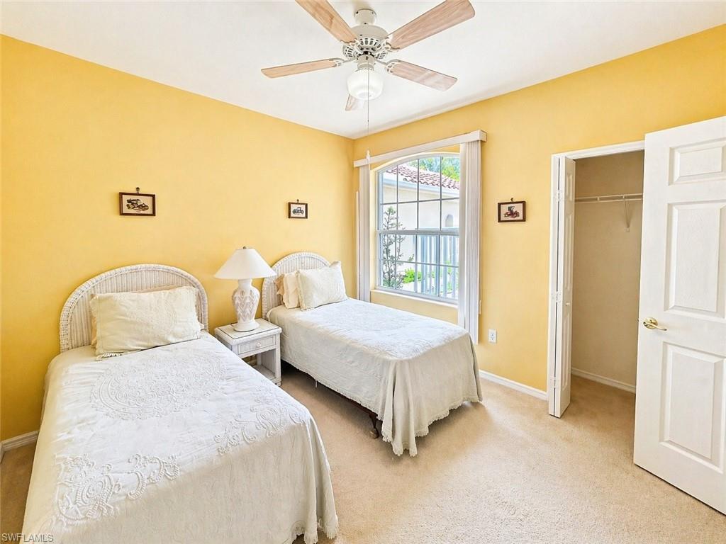Comfortable guest bedroom with ample closet space and natural light.