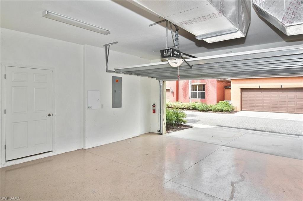 ...the roomy 2-car garage with epoxied flooring.  The door on the left opens into...