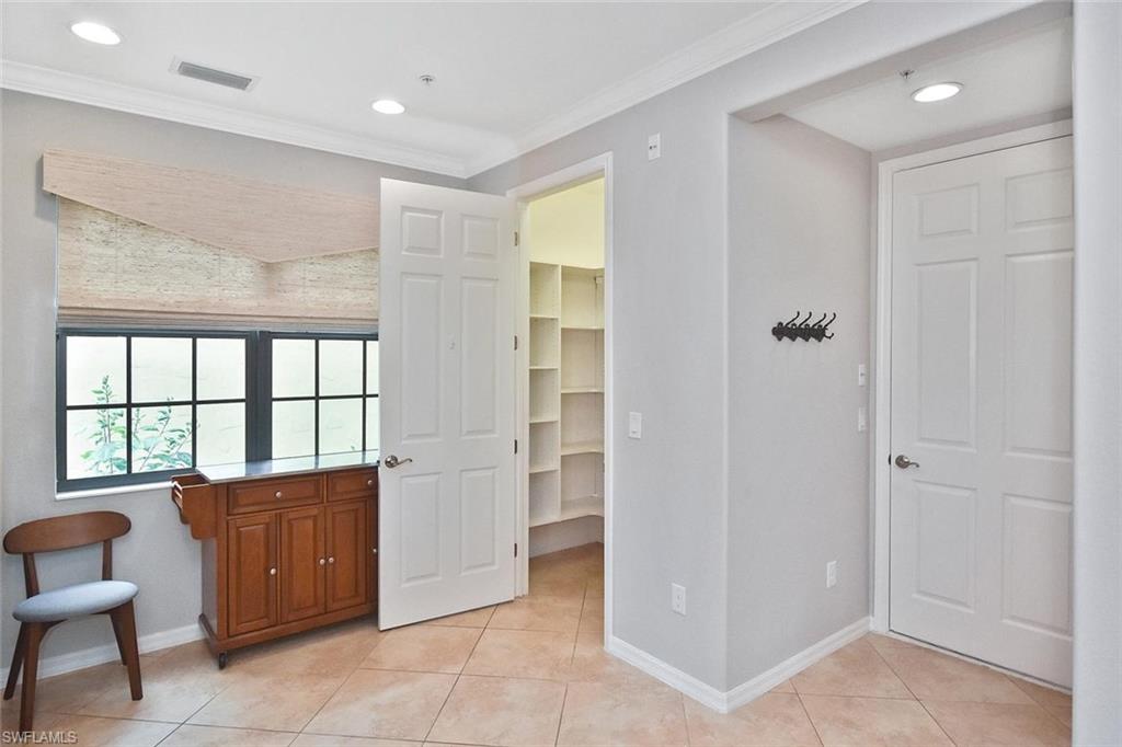 Custom shelving in the large walk-in pantry is great for those impulsive Costco splurges!  The door on the right opens into...