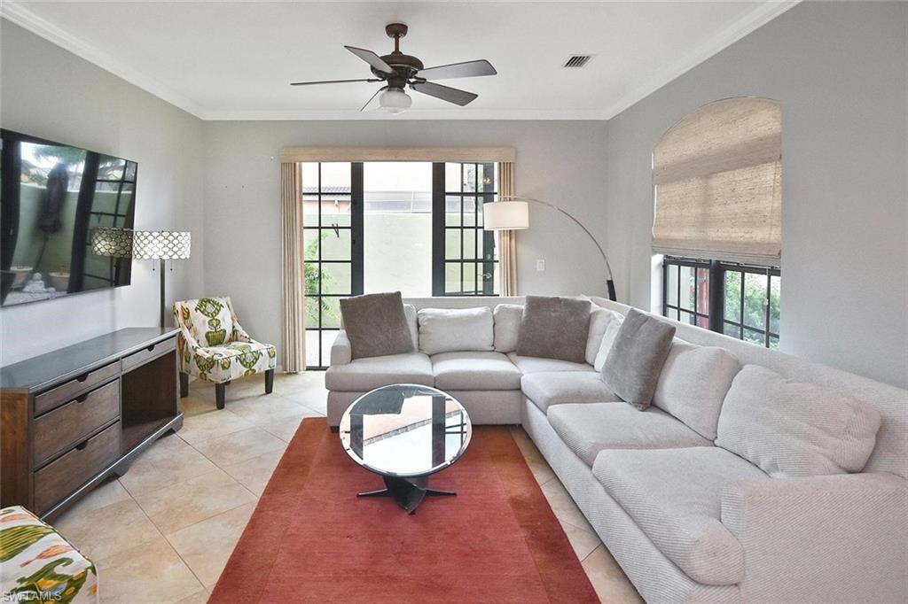 The spacious living room opens up to a pavered walled patio to let in the fresh air and warm Florida breezes!