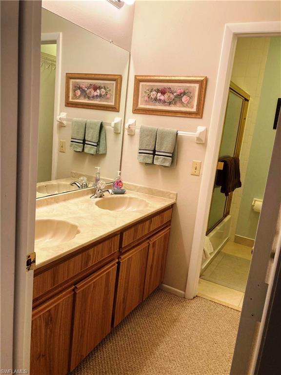 View of Primary Bathroom vanity with double sinks from primary bedroom.