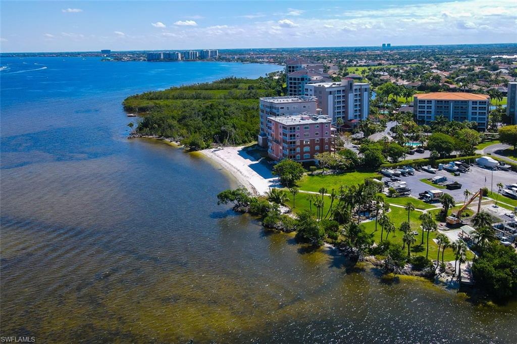 Aerial View shows Marina to right and Sandy Beach to left along the shore of the Caloosahatchee River.
