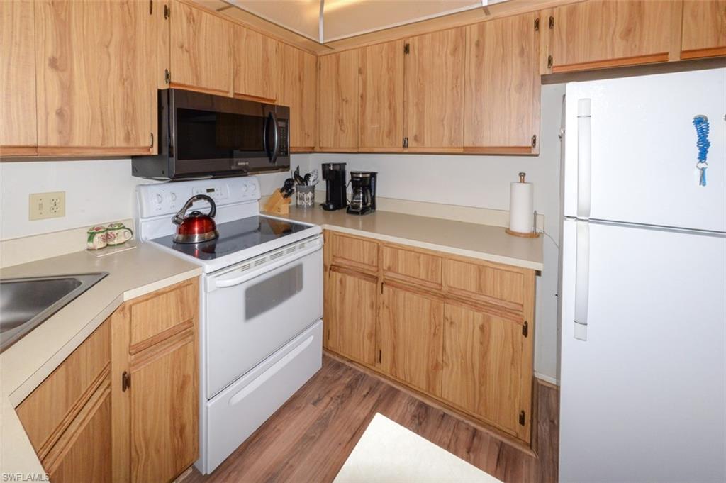 Kitchen features ample wood cabinetry and counter space
