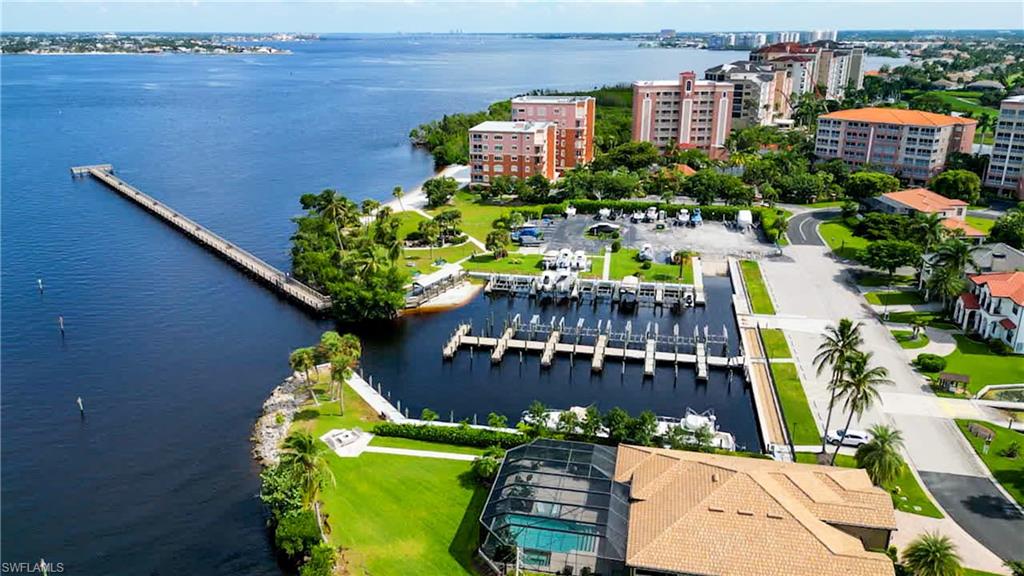 Aerial View of Community Marina shows Fishing Pier, Private Sandy Beach on River Bank, Pavilion, Park, & Boat Ramp. Pier was damaged and is currently being rebuilt