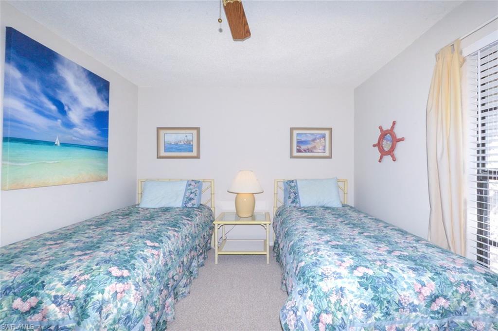 Spacious guest bedroom features 2 large windows for ample natural light and a view to the private courtyard.
