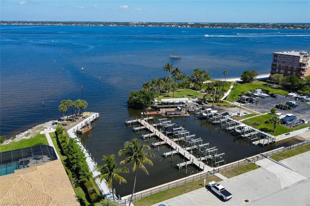Aerial View of Community Marina shows Private Sandy Beach on River Bank, Pavilion, Park, & Boat Ramp. Pier was damaged and is currently being rebuilt. Current picture shows equipment in place for rebuild of Fishing Pier.