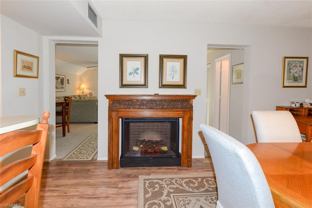 Dining room shows entry to living room to the left and entry to hallway leading to full bathroom and entry foyer to the right
