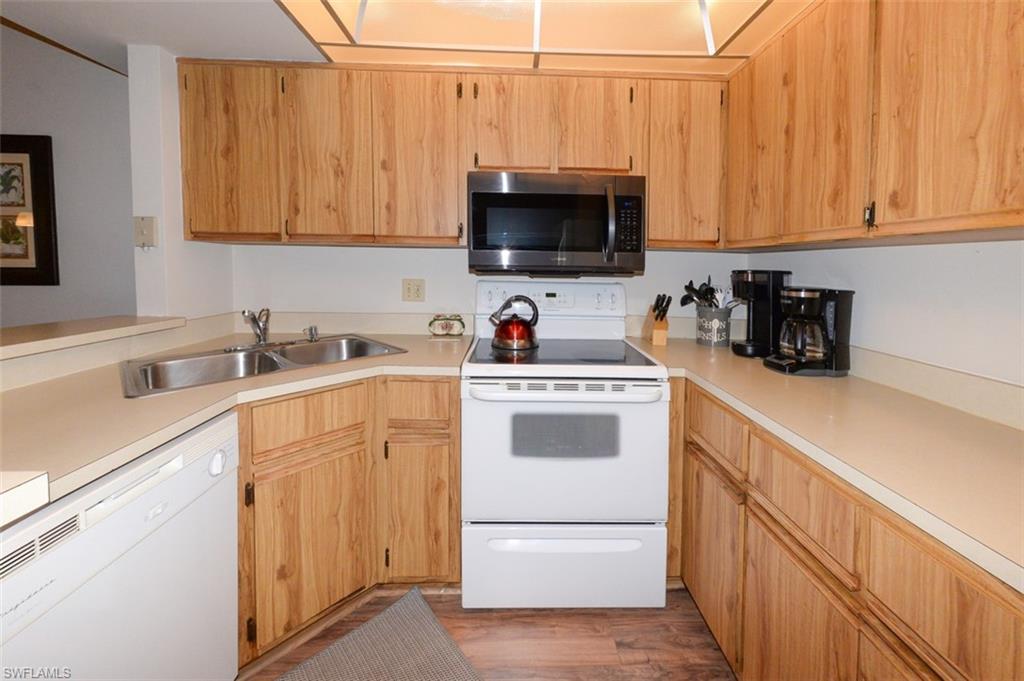 Kitchen features ample wood cabinetry and counter space