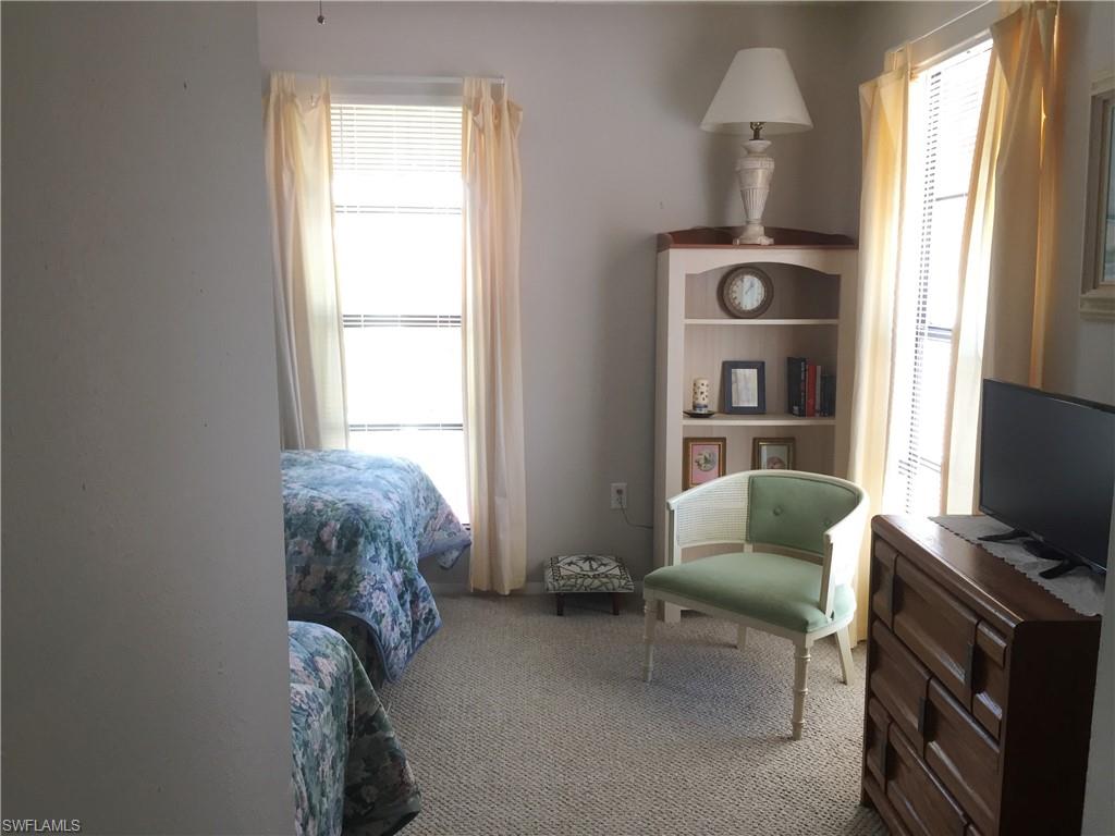 Spacious guest bedroom features 2 large windows for ample natural light and a view to the private courtyard.
