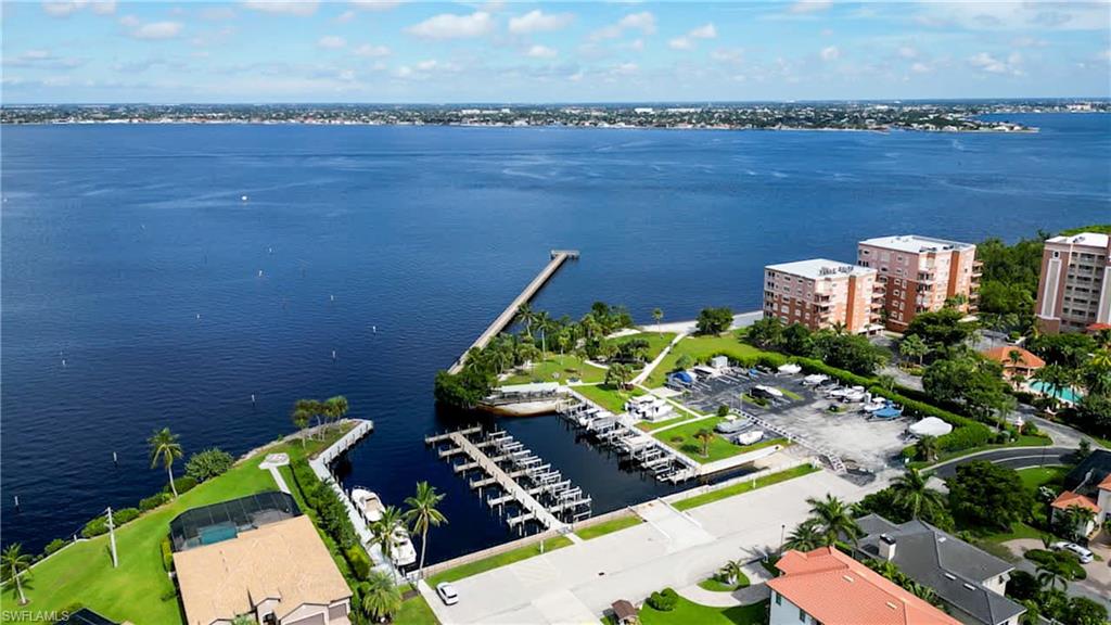 Aerial View of Community Marina shows Fishing Pier, Private Sandy Beach on River Bank, Pavilion, Park, & Boat Ramp. Pier was damaged and is currently being rebuilt