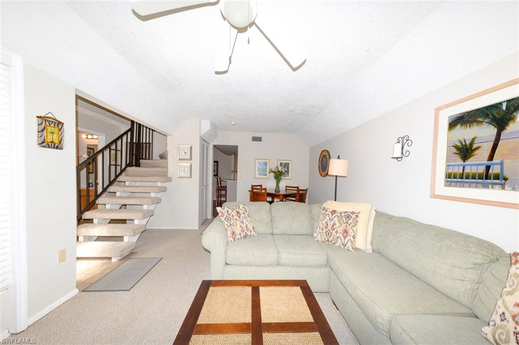 Spacious Living Room looking toward Breakfast area and kitchen to right and Staircase and entry foyer to left
