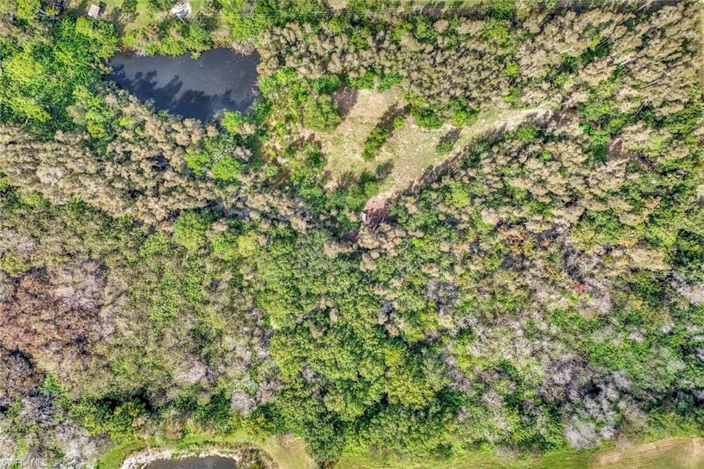 Aerial view of property and surrounding area featuring a large body of water