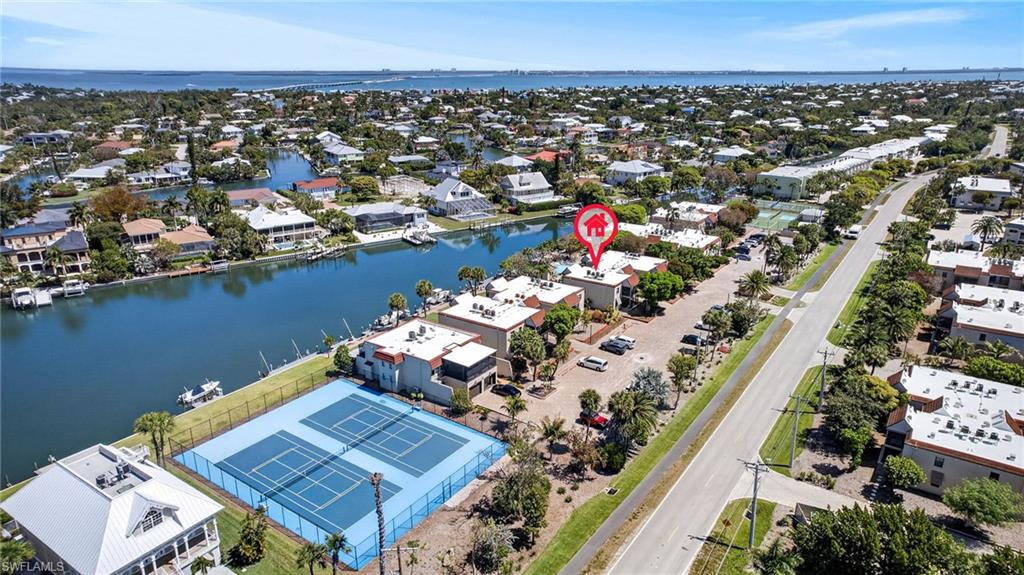 Aerial perspective showcasing a canal-front property with water access
