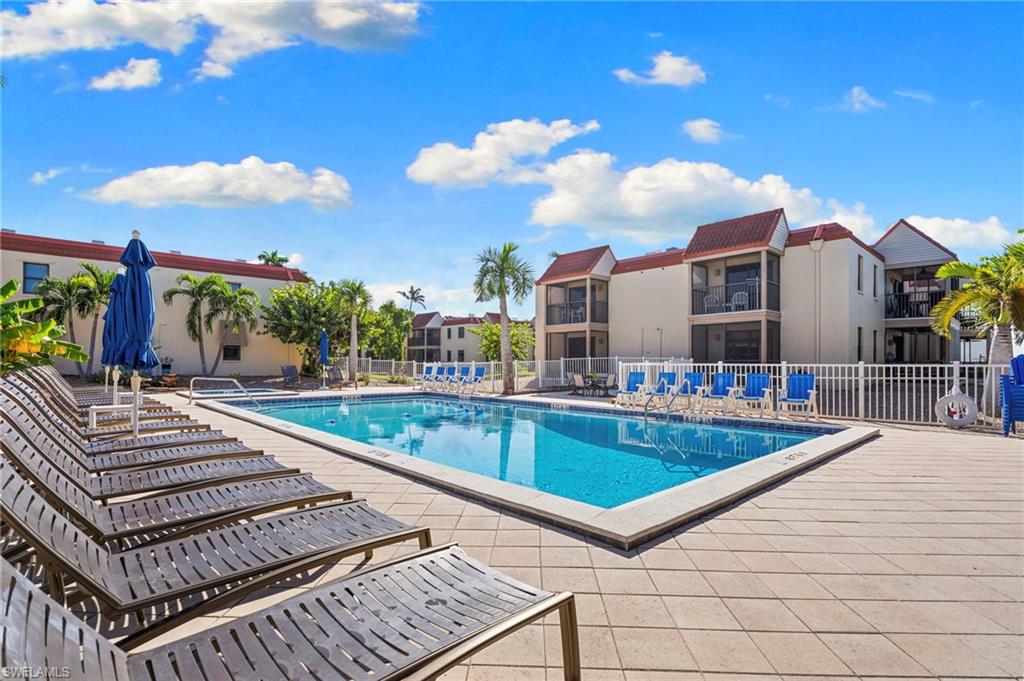 Expansive outdoor pool area featuring a rectangular pool with a paver deck surround