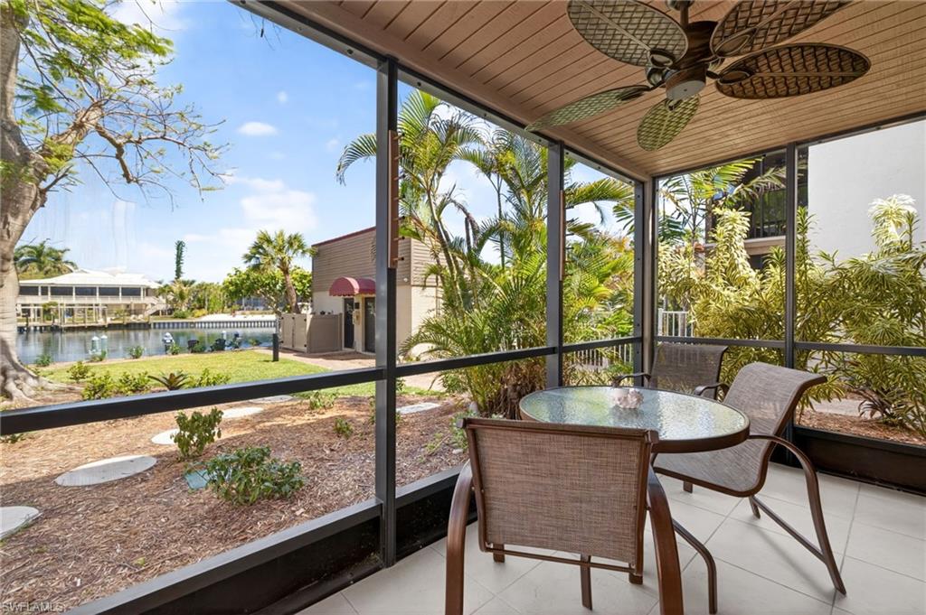 Screened outdoor patio featuring tile flooring, a wood-finish ceiling, and an overhead ceiling fan