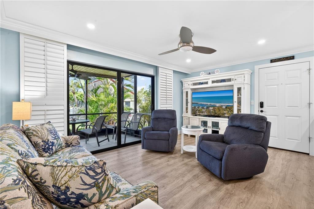 Open-concept living area featuring wood-finish flooring, recessed lighting, and a ceiling fan