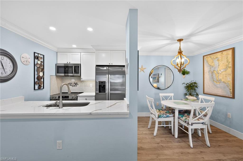 Kitchen and dining area featuring a breakfast bar with a solid surface countertop