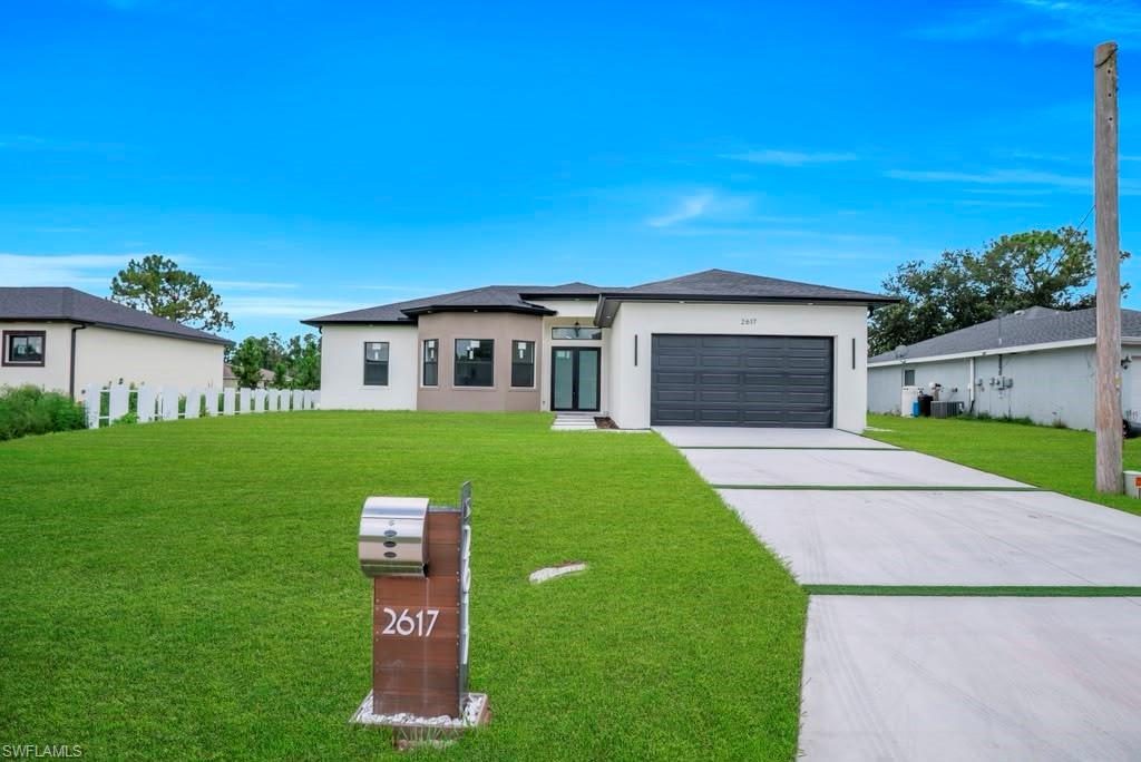 Contemporary single-story residence with a clean white and tan exterior