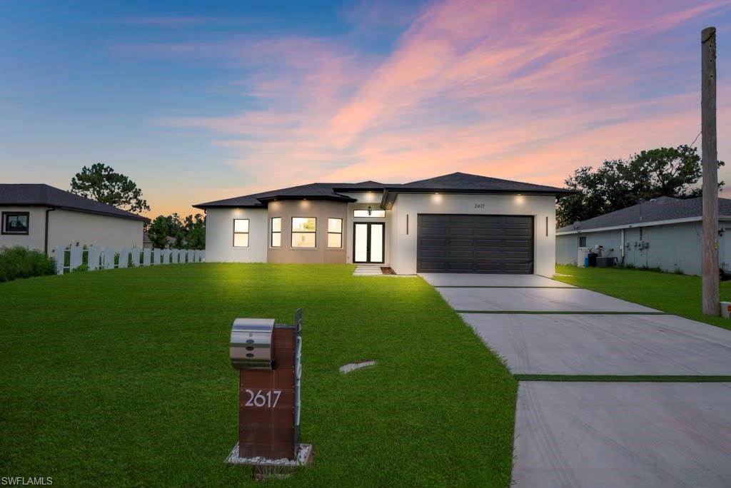 Contemporary single-story residence with a smooth stucco exterior and a dark, low-pitched roof