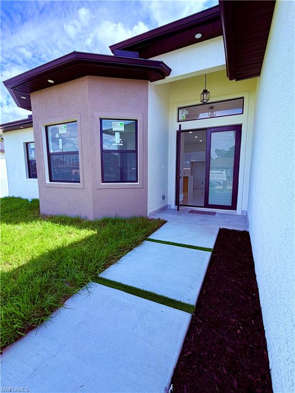 Contemporary exterior featuring a stucco finish and dark trim