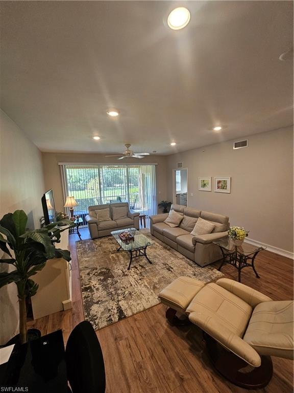 Living room featuring wood finished floors and recessed lighting