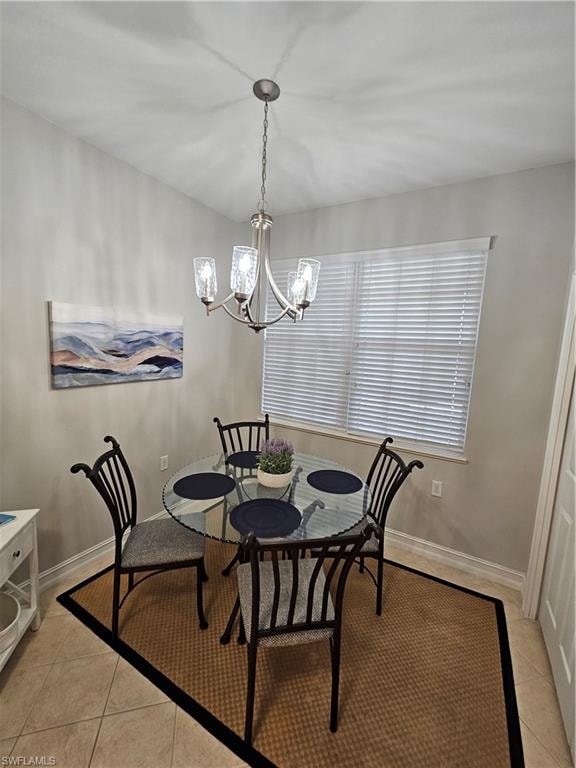 Dining room with a chandelier and light tile patterned floors