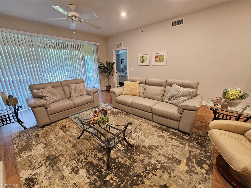 Living room with wood finished floors and a ceiling fan