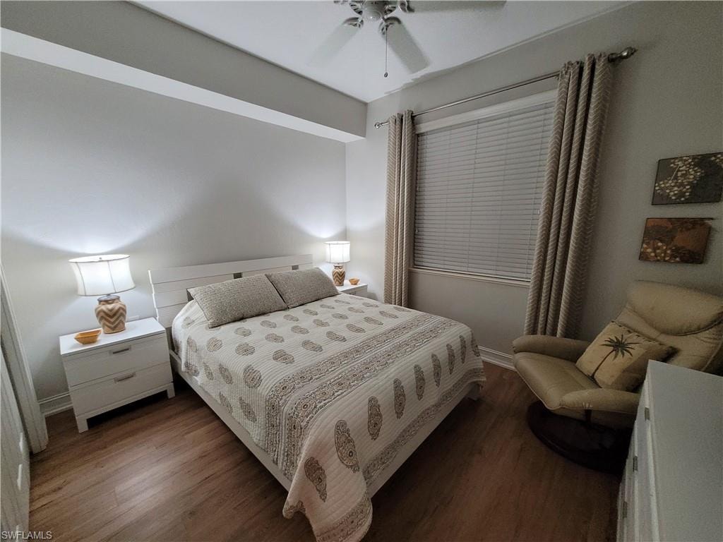 Bedroom with ceiling fan and dark hardwood / wood-style flooring