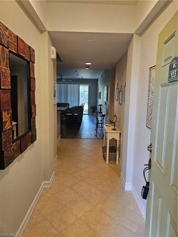 Corridor with light tile patterned flooring