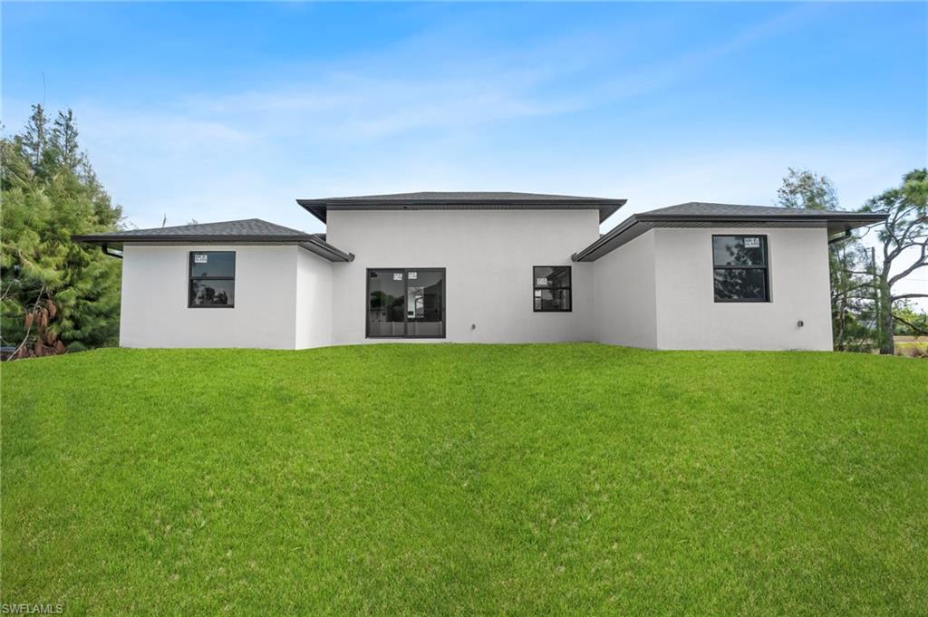 Rear view of property. Yard Rendered