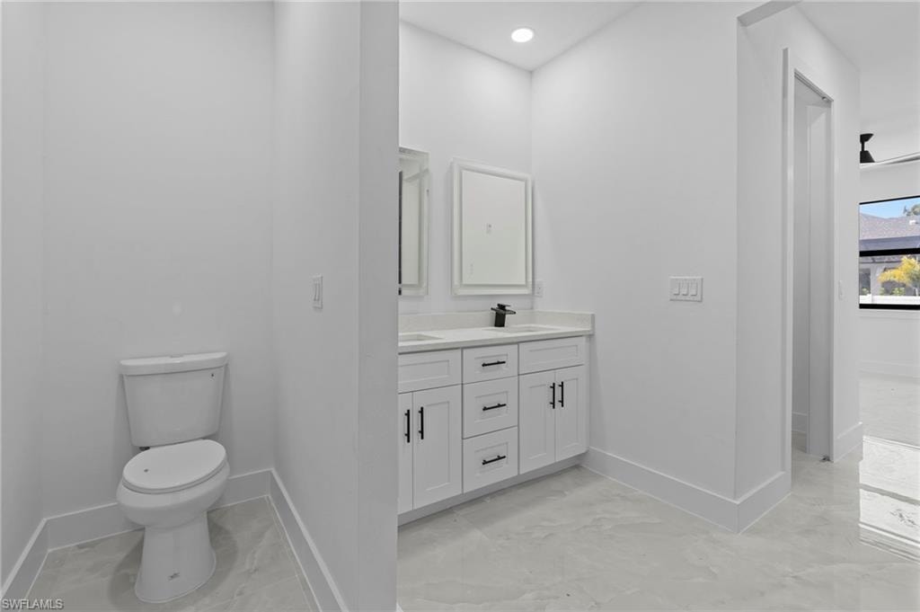 Bathroom featuring vanity and toilet