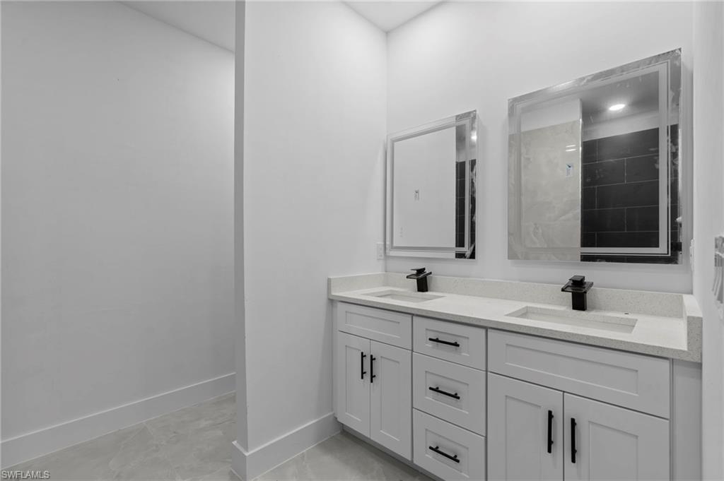 Bathroom featuring walk in shower and vanity
